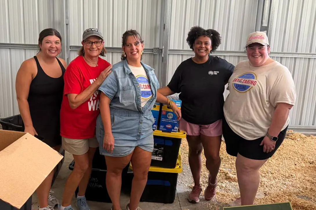 Greater Valdosta United Way volunteers stand with donated water, food and other items. 