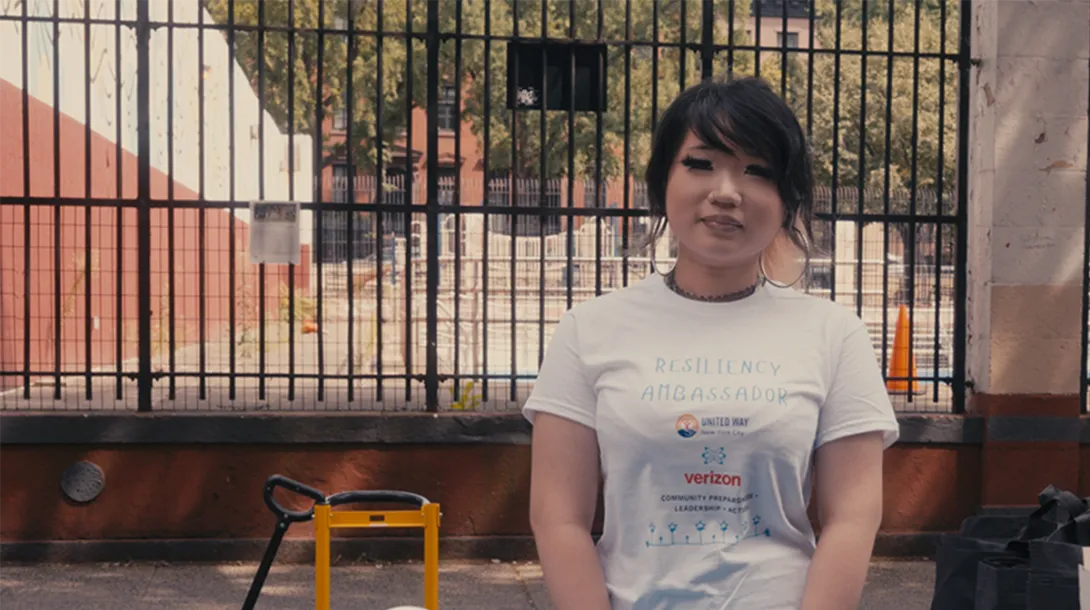 A young resiliency fellow wearing a T-shirt promoting the program at a community event. 